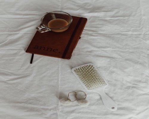 Person writing a daily routine journal with healthy breakfast